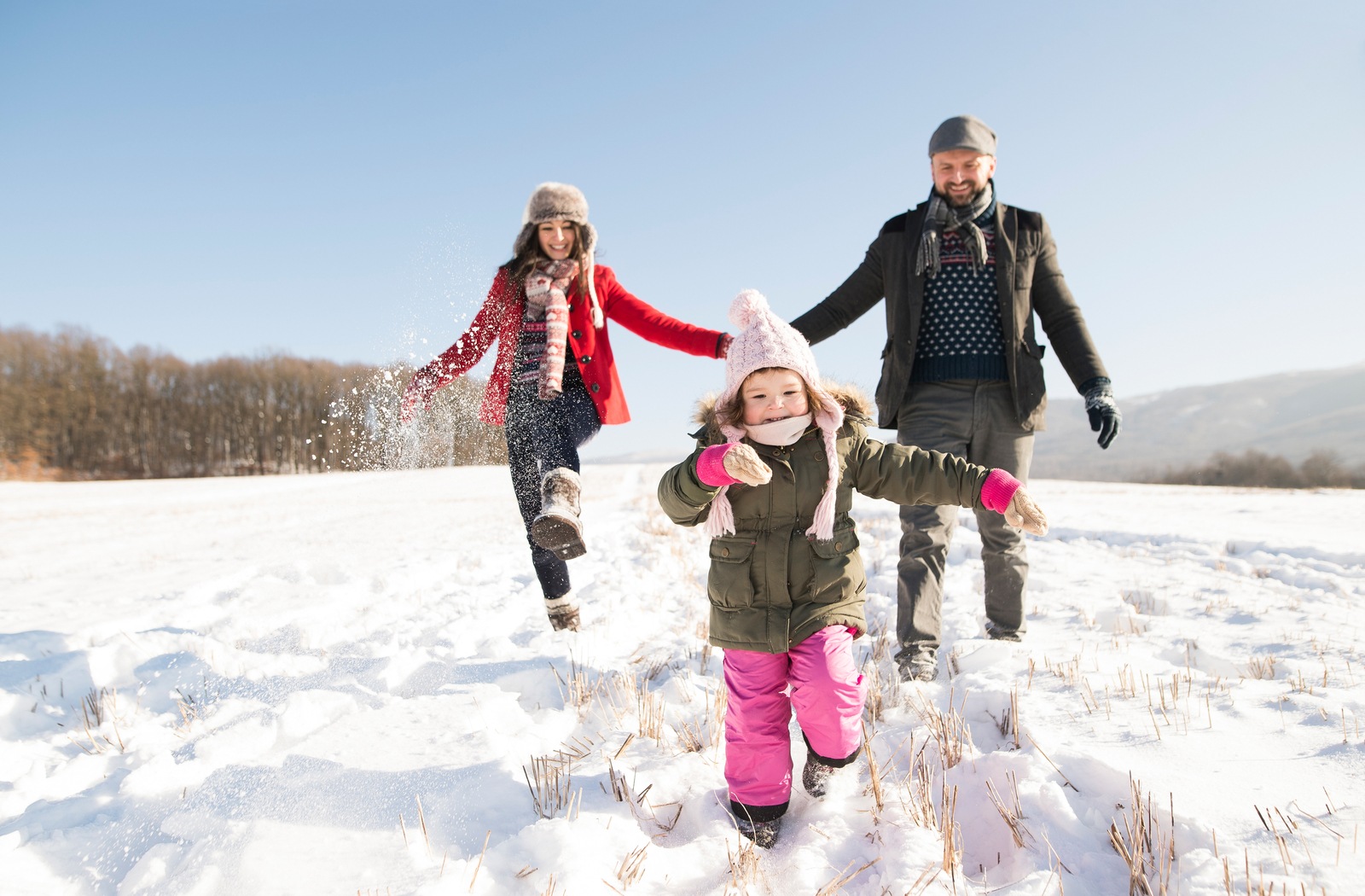 Family enjoying the winter playing in the snow